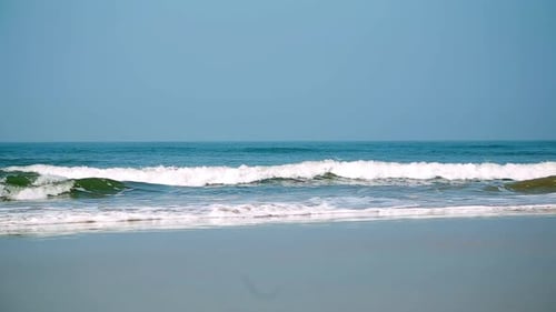 Calm Ocean Waves Gently Lap at a Serene Beach Inviting Relaxation in a Beautiful Setting Stock Clip