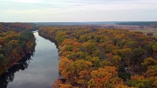 Autumn aerial above river with colorful riverbanks