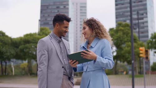 Young Professionals Discussing Business in Urban Environment