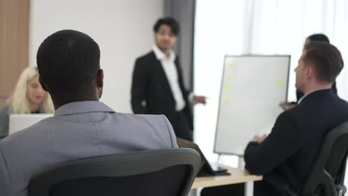 Business Meeting: Professionals Discuss Strategy with Whiteboard in Office