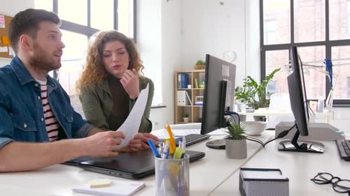 Coworkers Collaborating on a Project in Modern Office