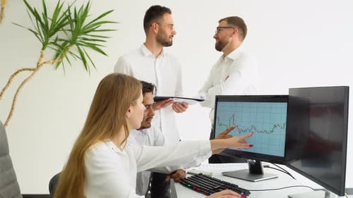 Business Team Collaborating on Data Analysis in Office