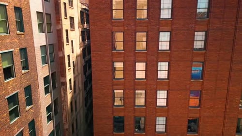 Footage at the facades of the high-rise red brick buildings.