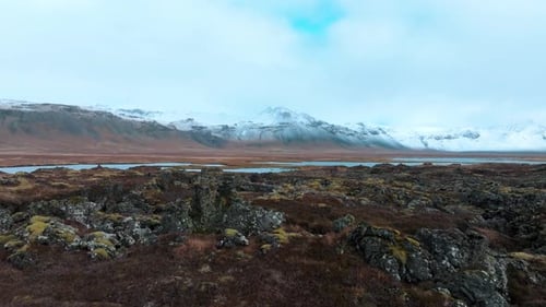 Lava field from a volcanic eruption that flowed to the valley in Iceland - pullback drone flyover