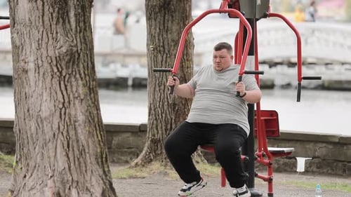 Man Exercising on Chest Press Machine in Park