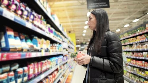 Woman Shopping for Groceries in Supermarket Aisle