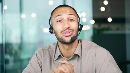 Webcam view. Customer service telemarketing male agent in office doing computer consultation