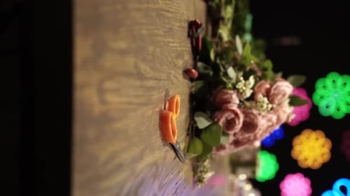 Florist Crafting Bouquet. Florist at Work. Florist makes bouquet in flower shop in Lviv Vertical