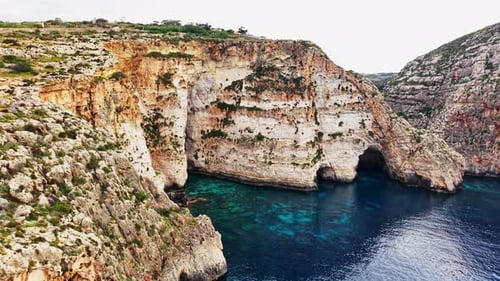 Explore the dramatic coastline of Malta from the sky during the day