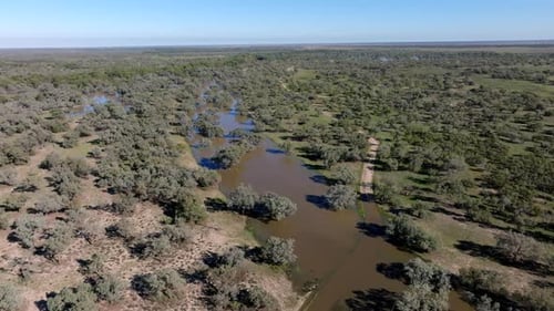 Aerial: Drone flying over flooded bushland in Bourke, NSW, Australia