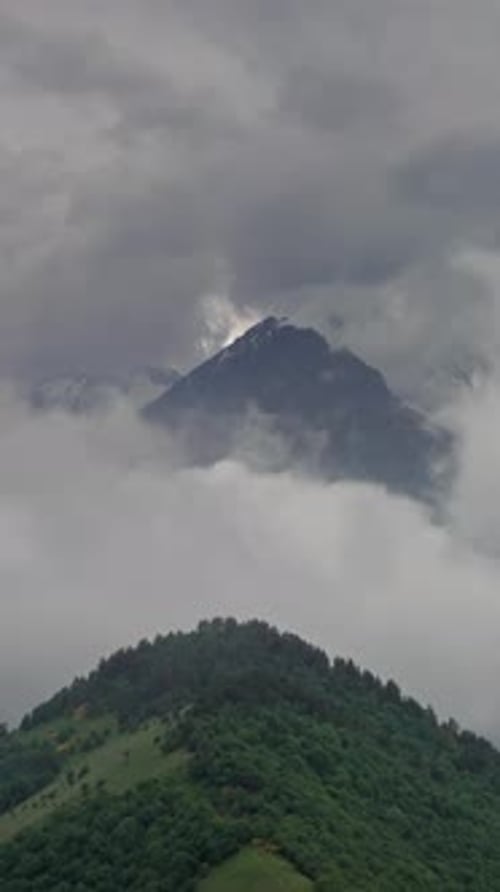 Lush Green Mountain Under a Cloudy Sky