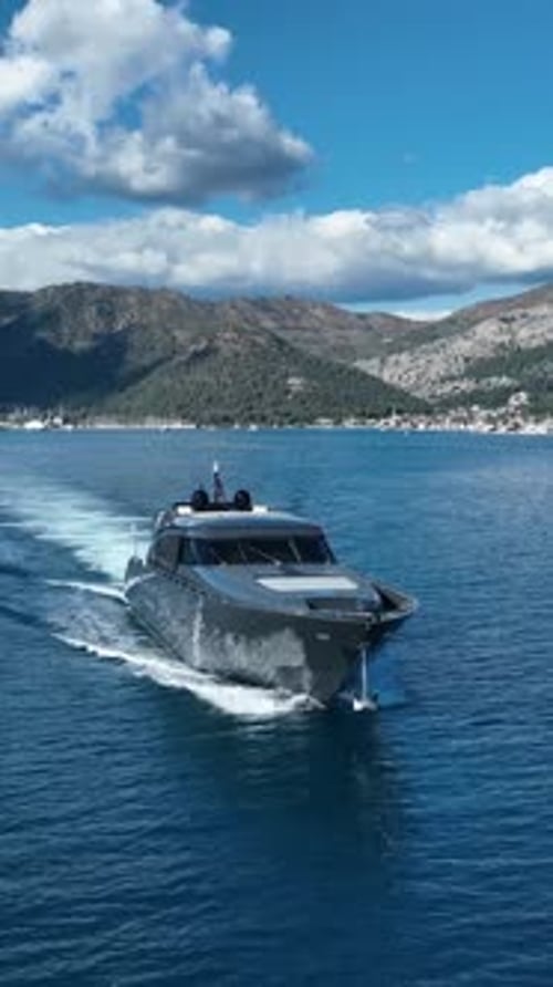 Aerial view of black yacht cruising in ocean