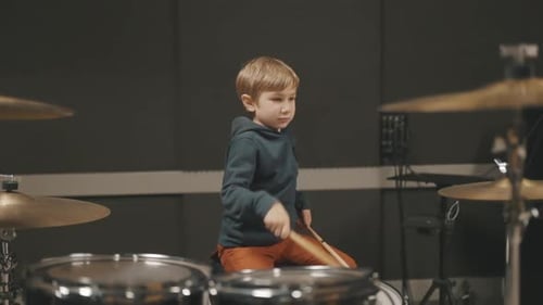 Talented Young Boy Playing Drums in Music Studio