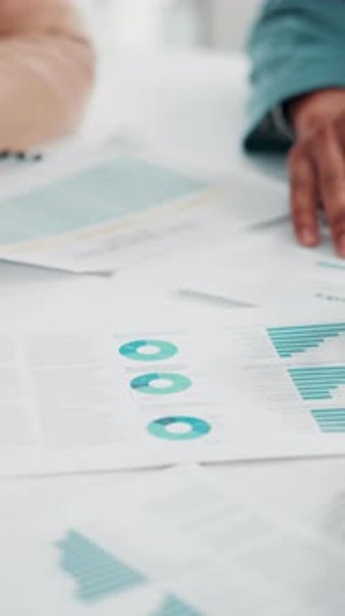 Hands, paperwork and graphs in meeting at office with review, team and investment planning