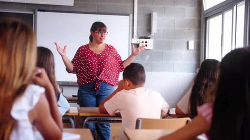 Enthusiastic Teacher Explaining Lesson to Students in Classroom