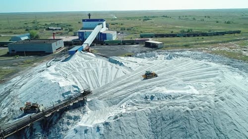 Aerial of Large Pile of Salt at Salt Producing Factory in Altai Region of Russia Tracktor Drives on