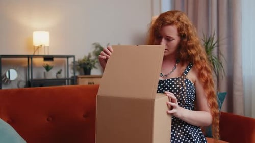 Woman Opens Package and Looks Disappointed