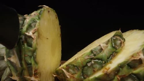 A whole pineapple with leaves, I cut it into round slices. Dolly slider extreme close-up inside.