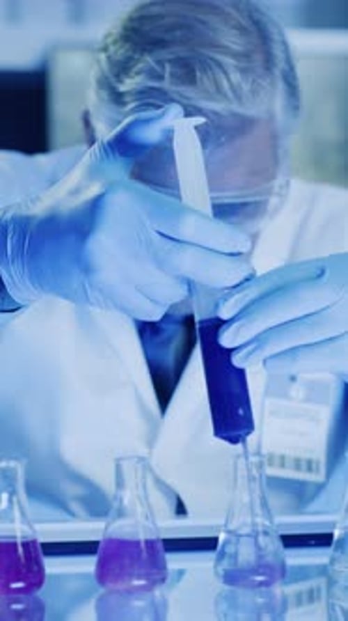 Man in Lab Coat Working With Test Tubes