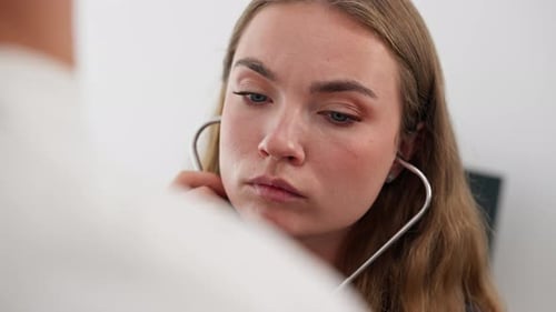 Close Up in a Modern Clinic in a Small Therapist s Office a Young Girl Doctor with a Stethoscope