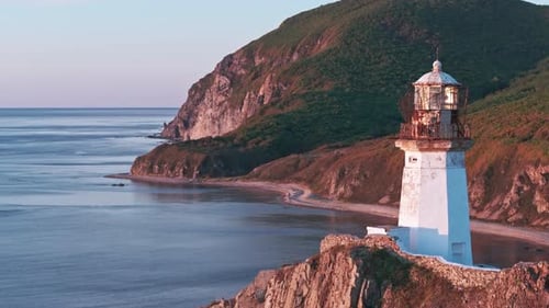 The Guiding Beacon A Majestic Lighthouse Illuminating a Rugged Cliff Overlooking the Vast Ocean