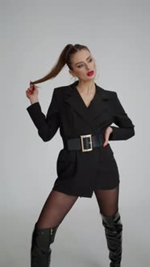 Woman in Black Blazer Poses in Studio