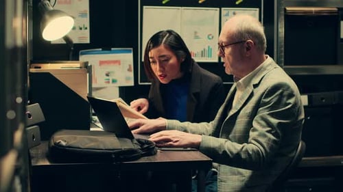 Team Collaborating on Laptop in Modern Workplace