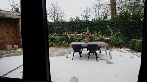 Outdoor Table and Chairs Sit on Concrete Patio