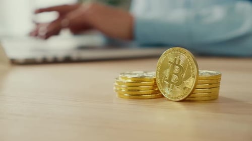 Close Up of Gold BTC Coins That Successful Young Woman Hold at Home