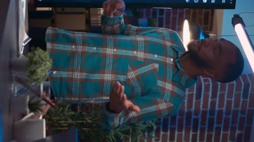 Man Presenting Business Charts in Modern Office at Night