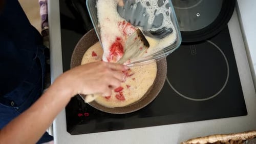 Woman Making a Tomato and Egg Breakfast Omelet