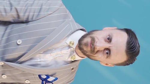 Vertical Video of Stylish businessman taking off his glasses and looking at camera.