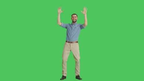 Long Shot of a Casual Man Dancing and Having Fun. Shot on a Green Screen Background.