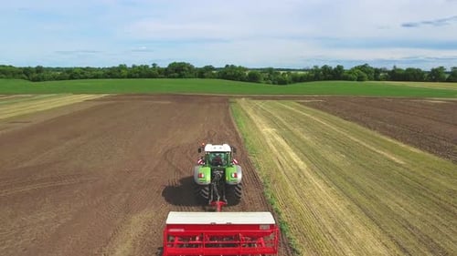 Agricultural Tractor Plowing Agricultural Field. Farming Tractor on Rural Field. Sky View