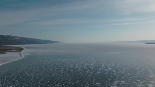 Winter aerial view of frozen Lake Baikal with islands and mountains, Russia