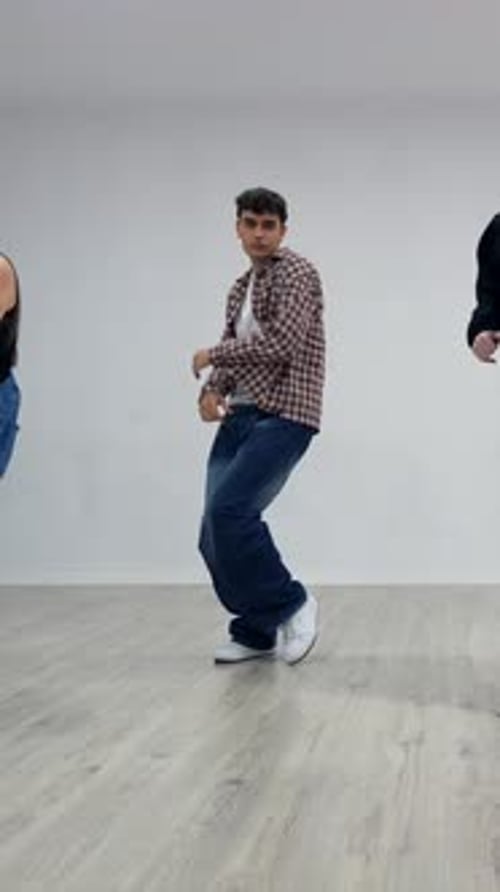 Energetic dancers performing choreography in dance studio