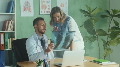 Doctors Reviewing X-Ray Results in Hospital Office