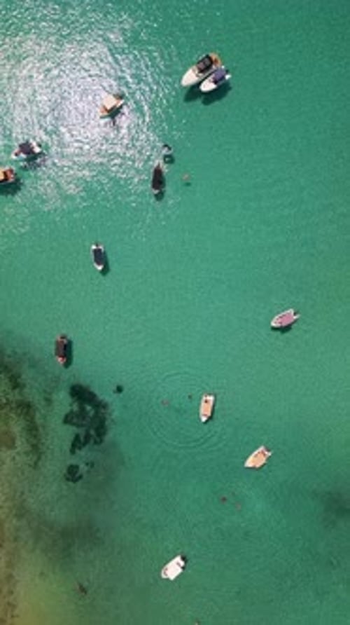 Aerial View of Boats Anchored in Shallow Turquoise Water Near the Coast Clear Sea Swimmers and