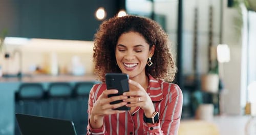 Smiling Woman Using Phone Indoors at Modern Workspace