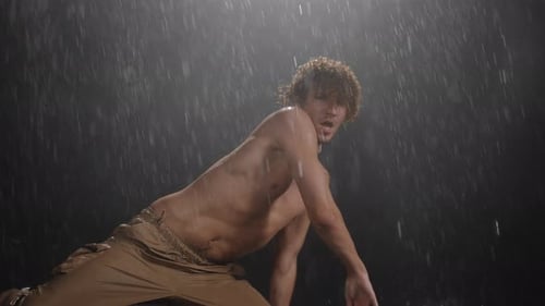 An Exhilarating Dynamic Dance Performance Unfolds Dramatically in a Rainy Atmosphere
