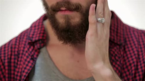 Closer Portrait of Man Touching His Perfect Beard
