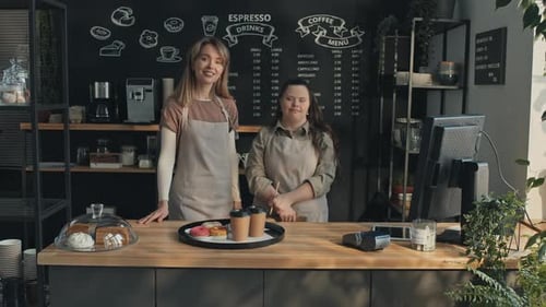 Woman With Disability And Her Colleague In Small Cafe
