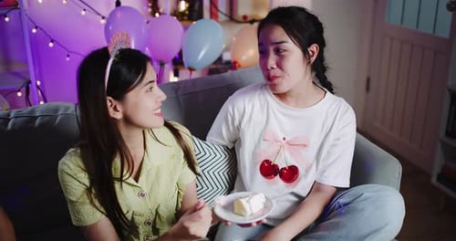 Young Women Sharing Birthday Cake and Celebrating