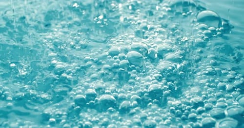 Many bubbles in water close up, abstract water wave with bubbles in slow motion. Shot on super slow