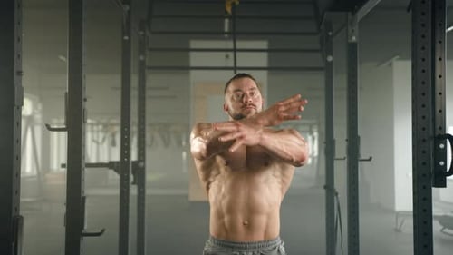 Bodybuilder Flexing Muscles in Gym