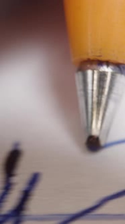 Extreme Close Up Writing Blue Pen on Paper