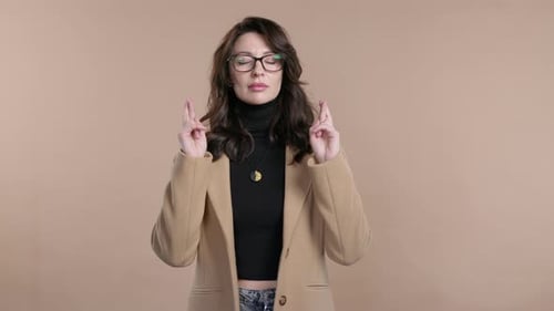 Woman Crossing Fingers Hoping for Good Luck