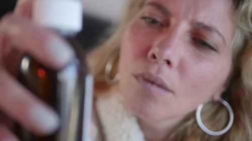 Woman Reading Medicine Label in Close Up