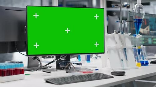 Green Screen PC in Lab Next to Tablet with Interface Showing Genetic Markers