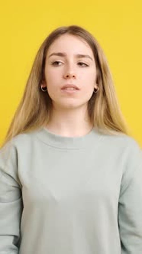 Worried Woman Reads Upsetting News on Mobile Phone